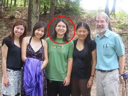 Jonathan McKinsey, circled in green in the middle, and his father on the right, posing with others outdoors.