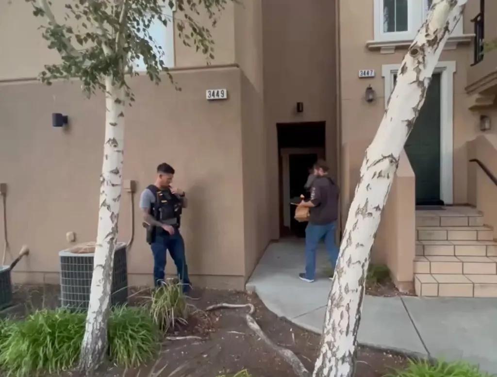Police officers outside the residence of Candice Jang.