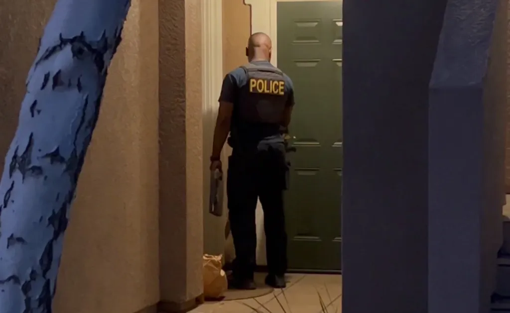 A police officer stands at the door of Candice Jang's residence in Dublin, California.