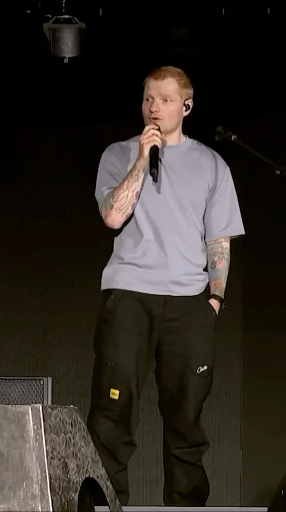 Singer Ed Sheeran on stage, addressing a controversy.
