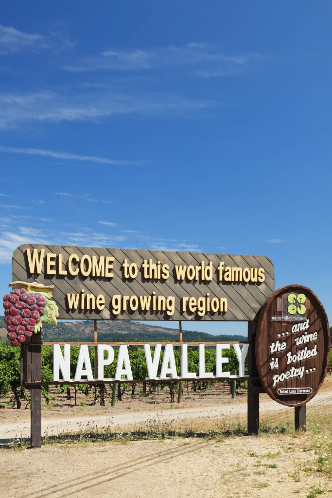 Welcome sign to Napa Valley, featuring a wine barrel and the quote, 