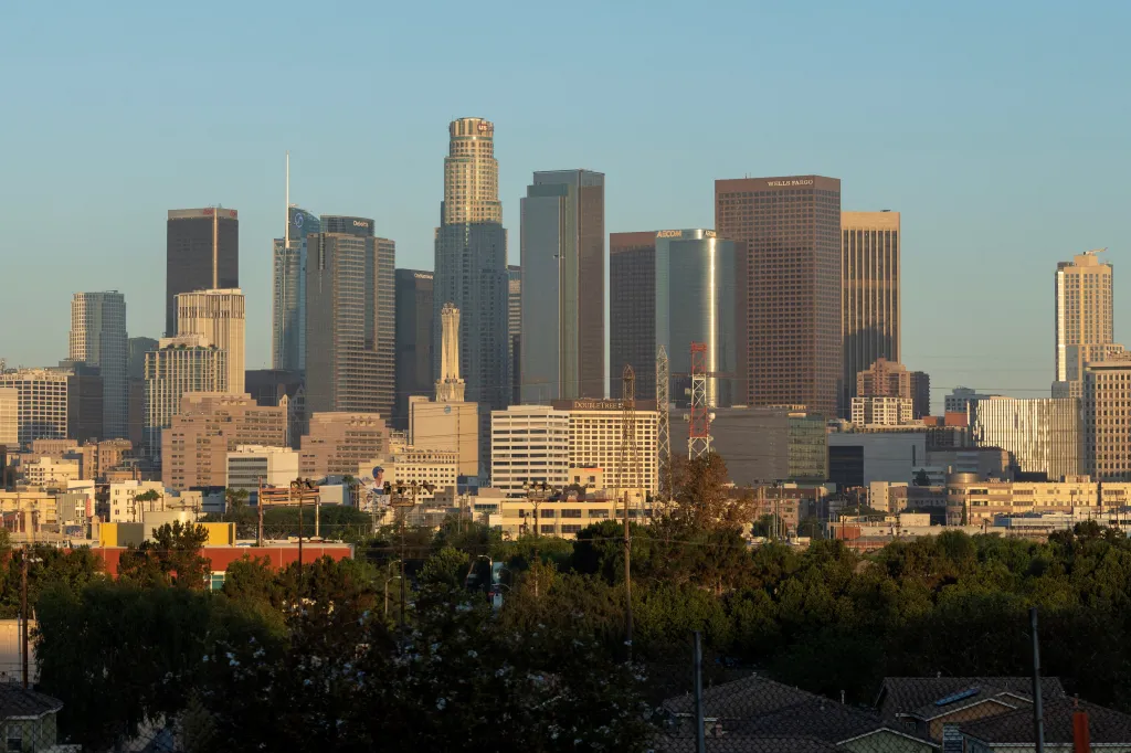 Skyline of Los Angeles, California, with tall buildings against a clear sky.