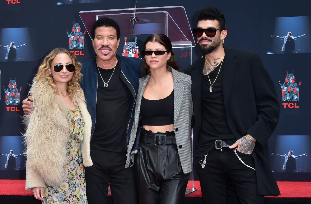 Lionel Richie poses with his children Nicole, Sofia, and Miles at his Hand and Footprints ceremony.