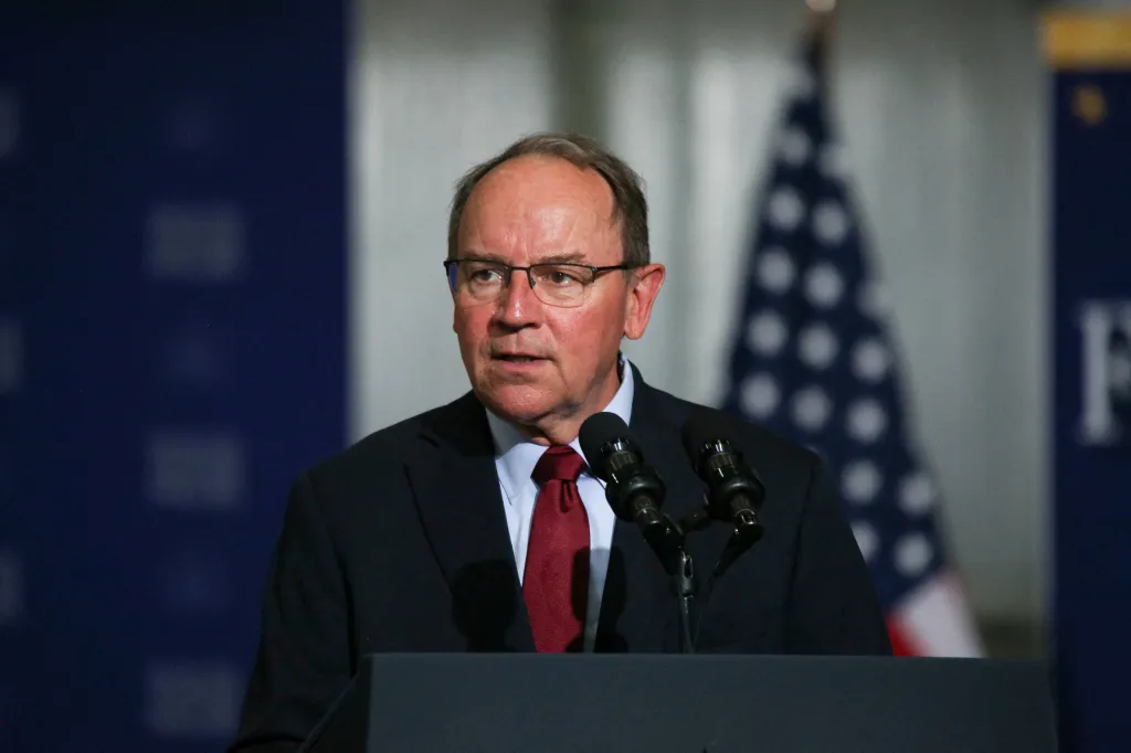 Rep. Tom Tiffany (R-WI) speaks from a podium with microphones.