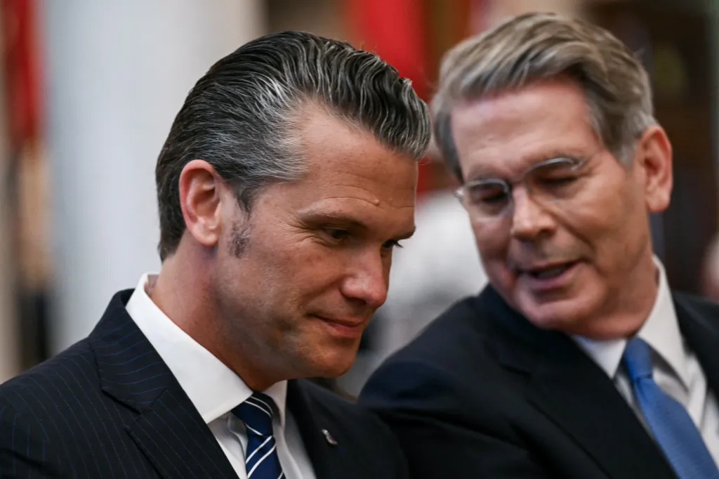 US Secretary of Defense Pete Hegseth speaks with US Secretary of Treasury Scott Bessent.