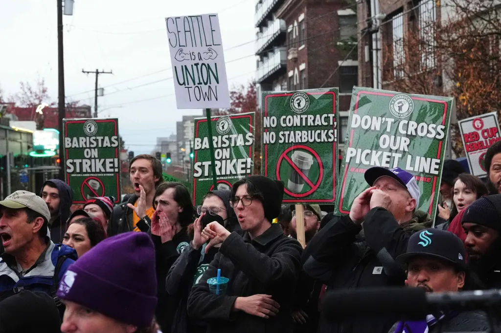 Starbucks employees and supporters holding protest signs in Seattle.