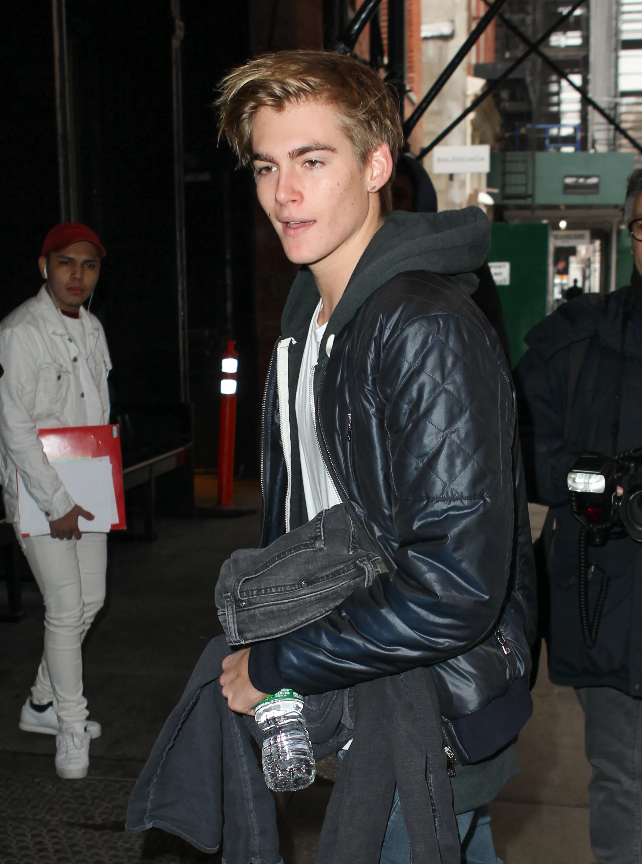 Presley Walker Gerber walking in New York City while holding a water bottle.