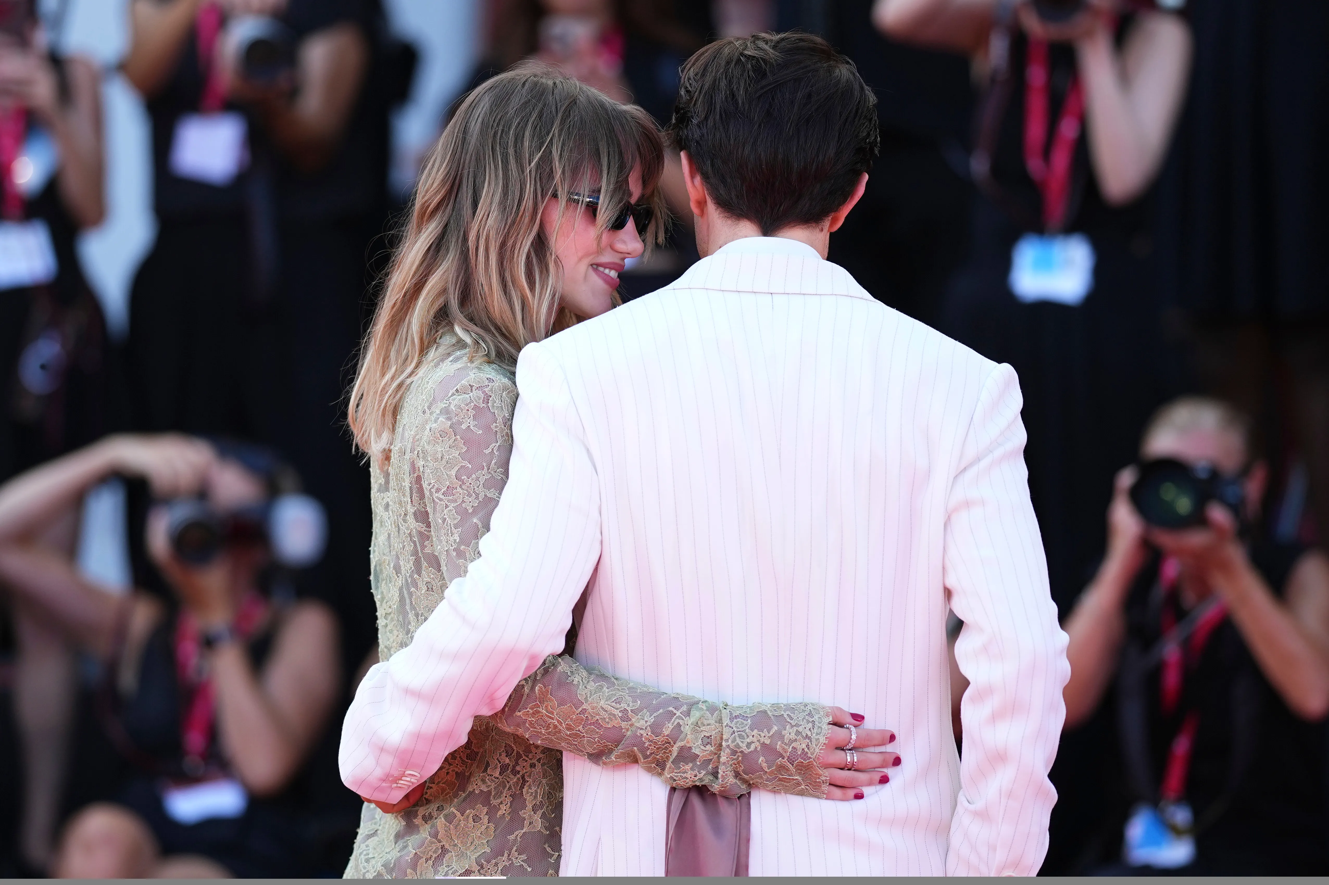 Suki Waterhouse and Robert Pattinson pose for photographers.