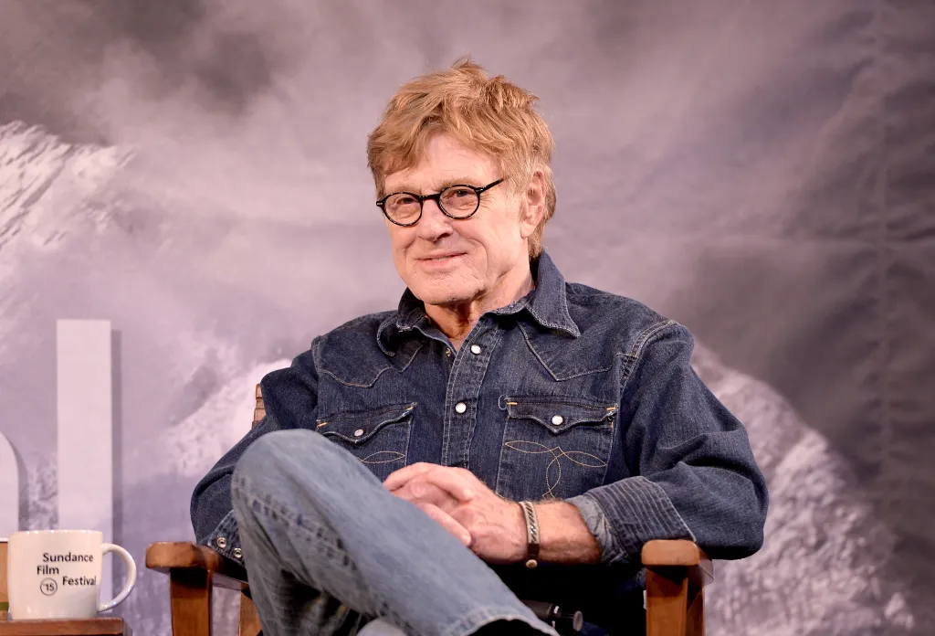Robert Redford, president of the Sundance Institute, sits smiling during the 2015 Sundance Film Festival.