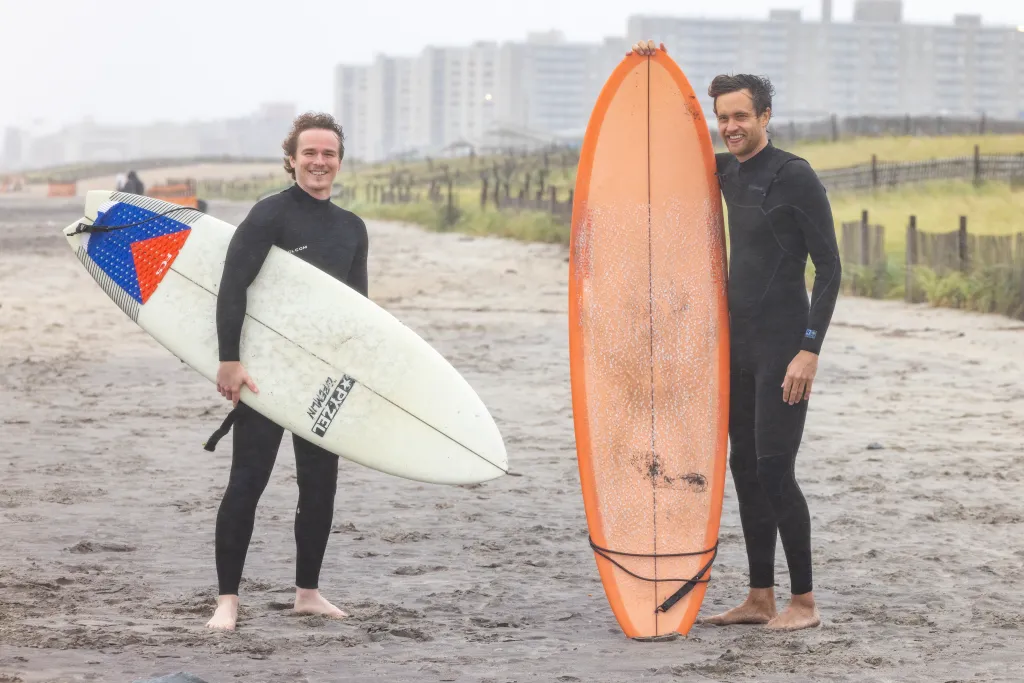 Garret and Brian pose with their surfboards on Beach 90th Street in Far Rockaway, Queens.
