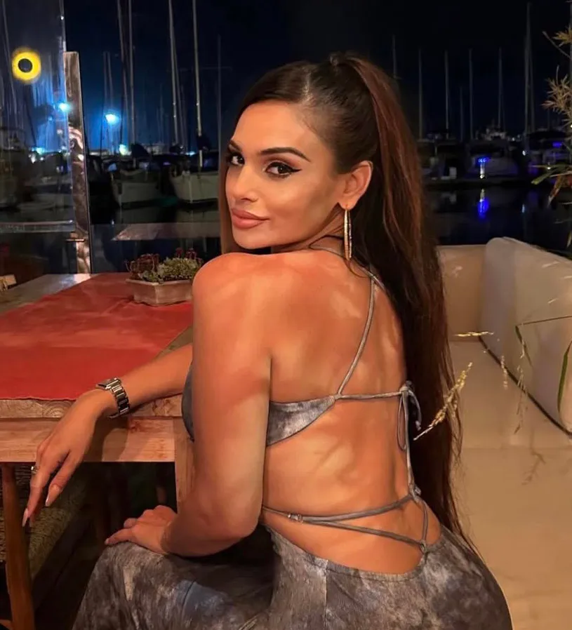 Sydna Konstin in an evening dress looking over her shoulder.