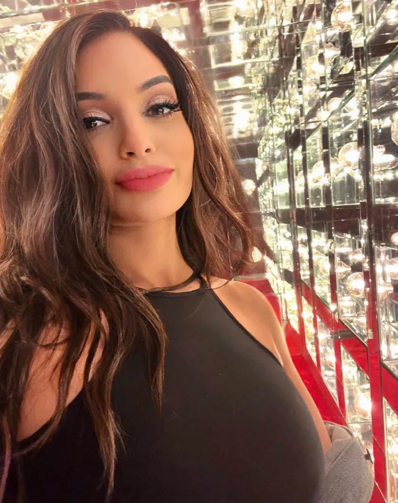Sydna Konstin in a black top with long brown hair.