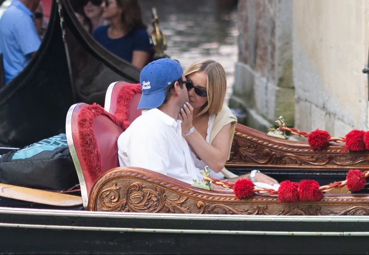 Sydney Sweeney and Scooter Braun kissing in a gondola in Venice.