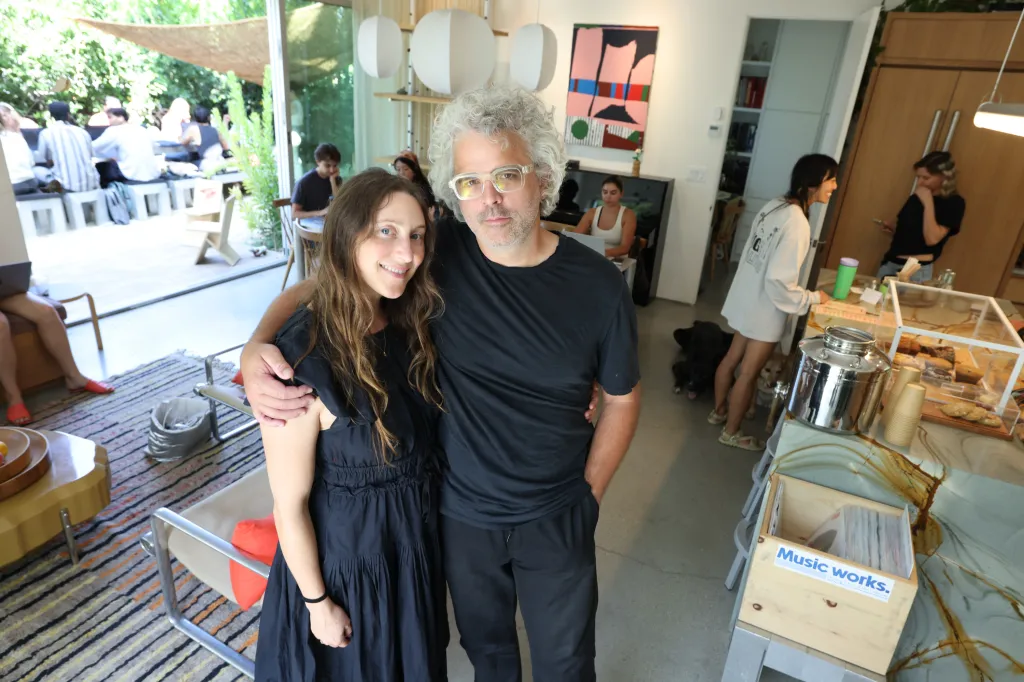 Sydney Wayser and Isaac Watters, owners of GRANADA, pose in their Los Angeles home that doubles as a community coffee house.