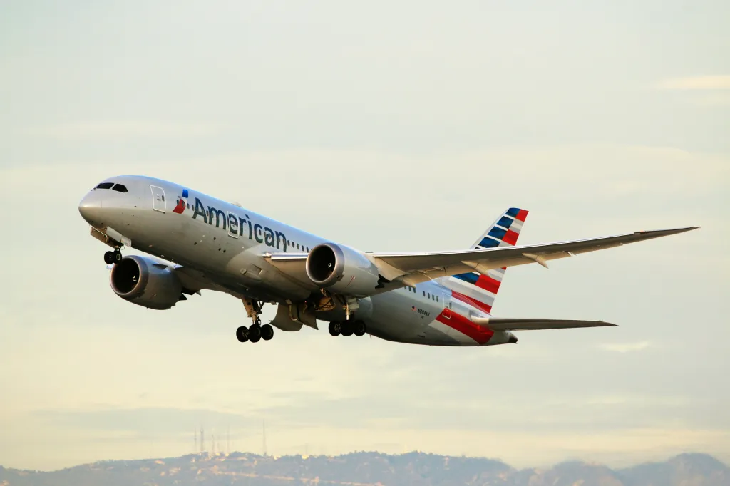 An American Airlines Boeing 787-8 Dreamliner airplane taking off at LAX Airport.