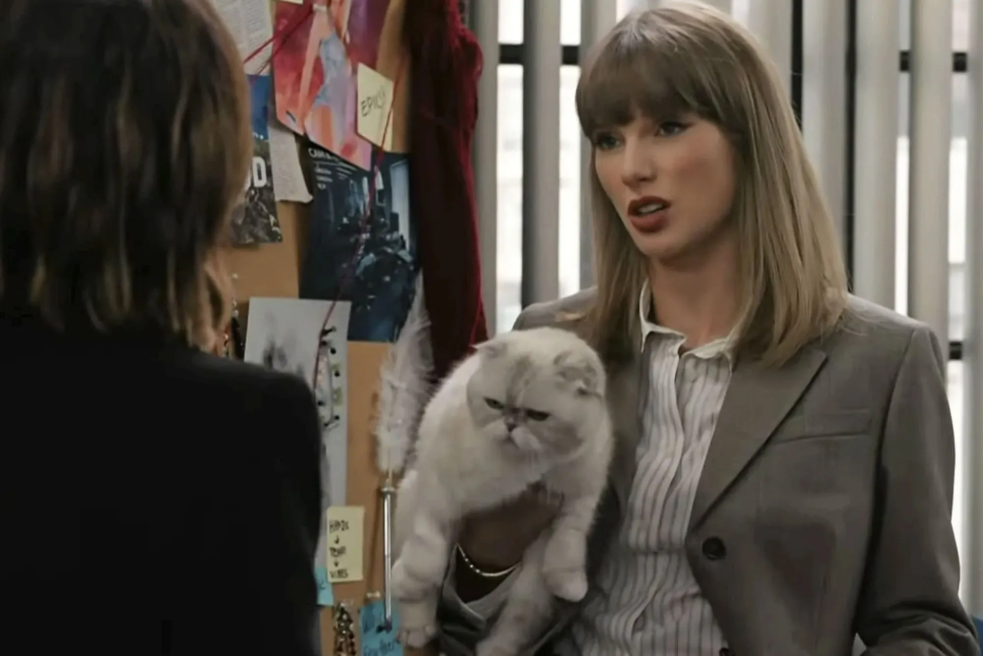 Taylor Swift holding a white cat.