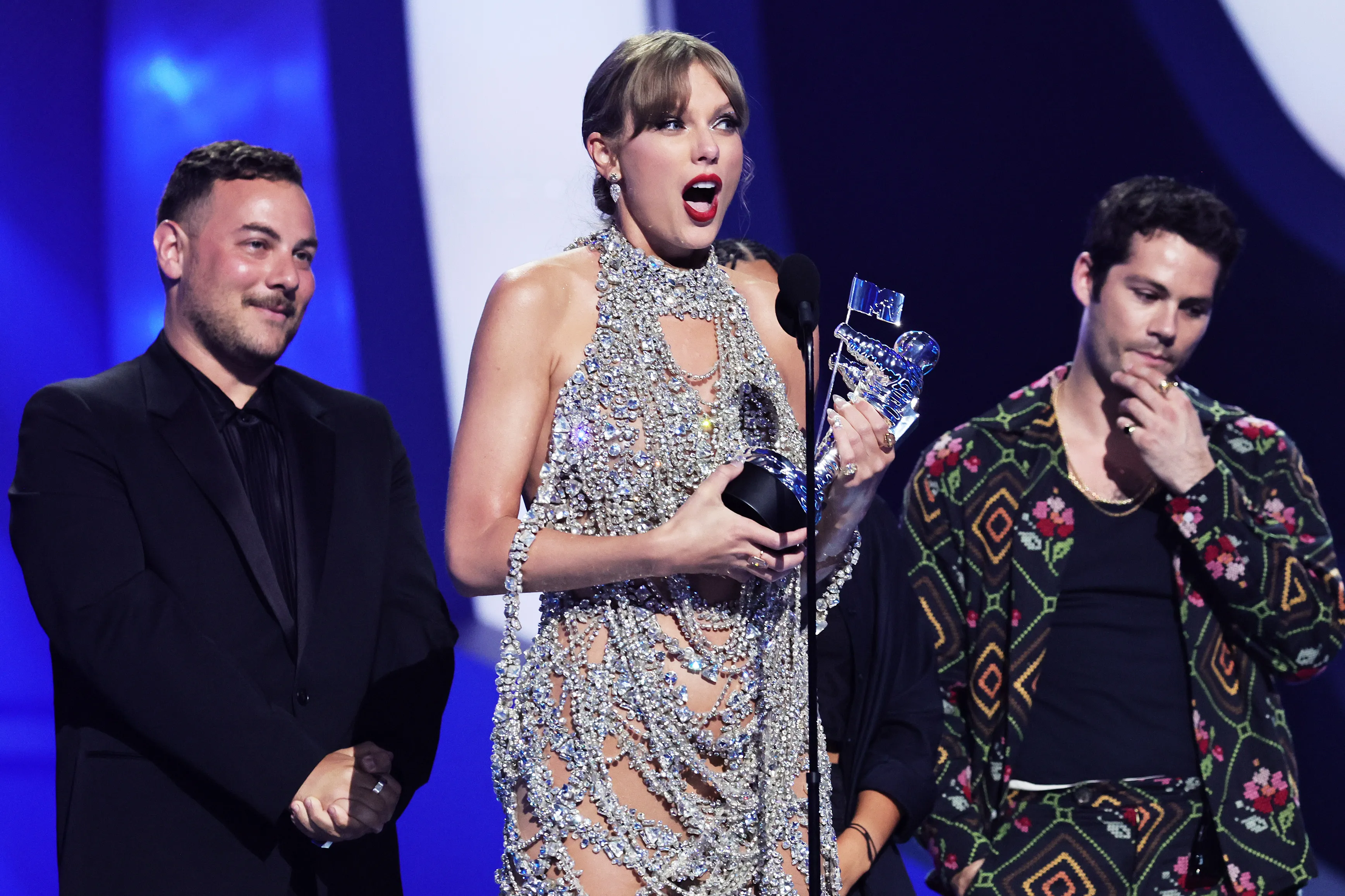 Taylor Swift accepts an award onstage.
