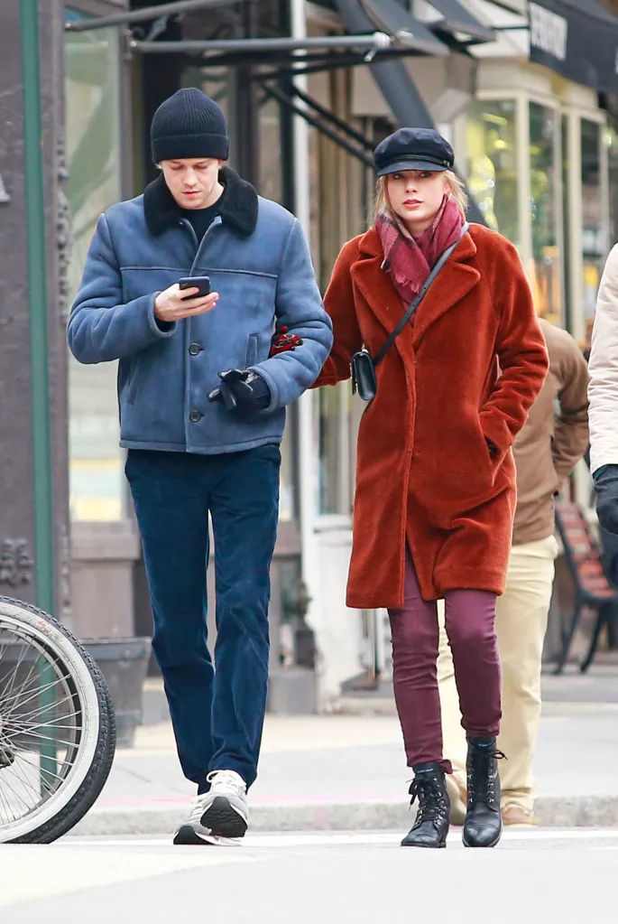 Taylor Swift and Joe Alwyn walk arm in arm in New York City.