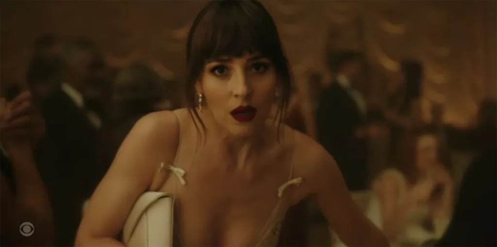 Taylor Swift looking directly at the viewer with an open mouth in a music video frame.