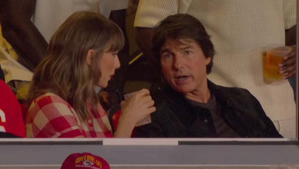 Taylor Swift and Tom Cruise sit next to each other at a Chiefs game.