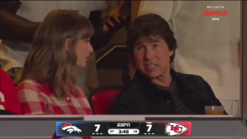 Taylor Swift and Tom Cruise sit next to each other at a Chiefs game.