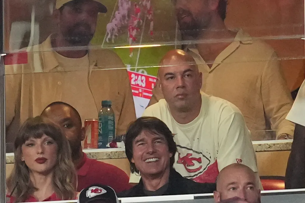 Taylor Swift and Tom Cruise watching a football game at Arrowhead Stadium.