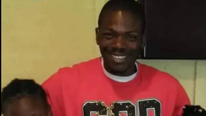 Terrika Myers, a woman with dark skin and hair, smiles at the camera while wearing a red shirt with white lettering.
