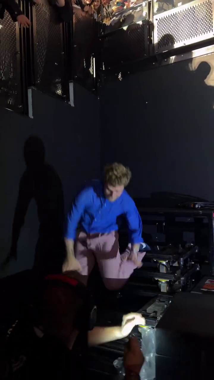 Alex Warren falling off stage during a concert.