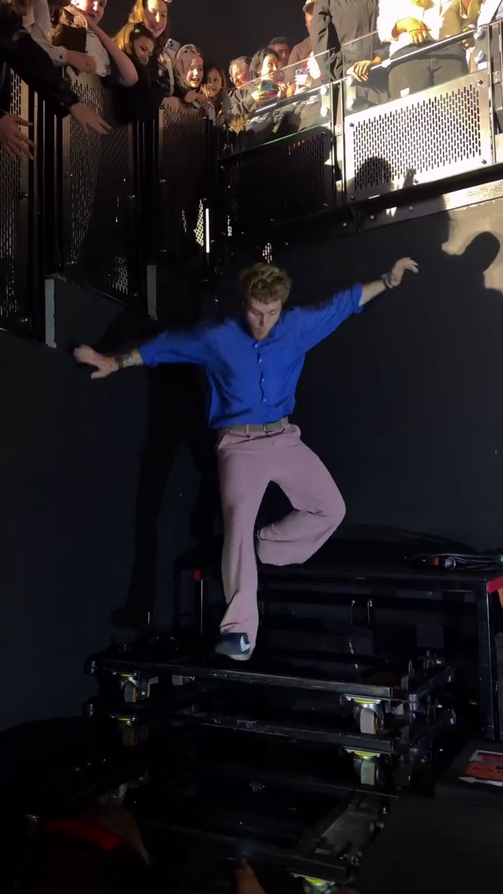 The British pop singer, dressed in a blue shirt and cream trousers, leapt onto recording kit placed in a side tunnel and landed on two feet only to stacked it moments later.