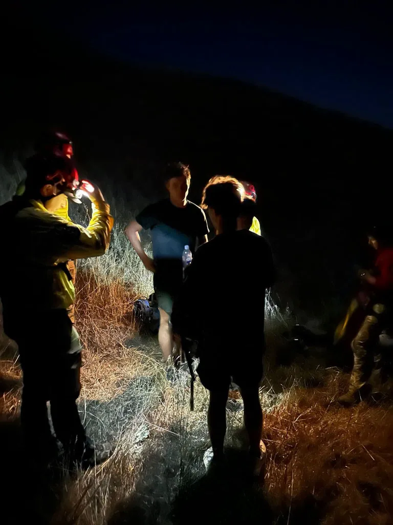 Search-and-rescue team assisting three hikers at Limekiln State Park.