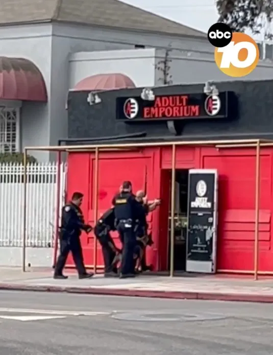 Police officers with a K-9 outside an 