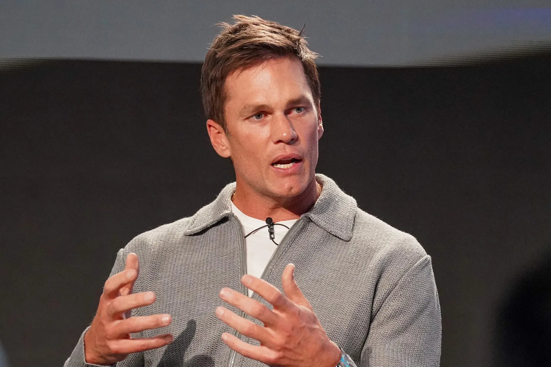 Tom Brady speaking at the JP Morgan Chase athletic council panel discussion.