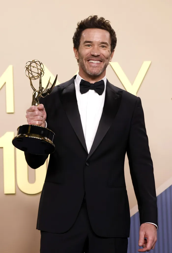 Tom Pelphrey holding his Emmy Award for Outstanding Supporting Actor in a Drama Series.