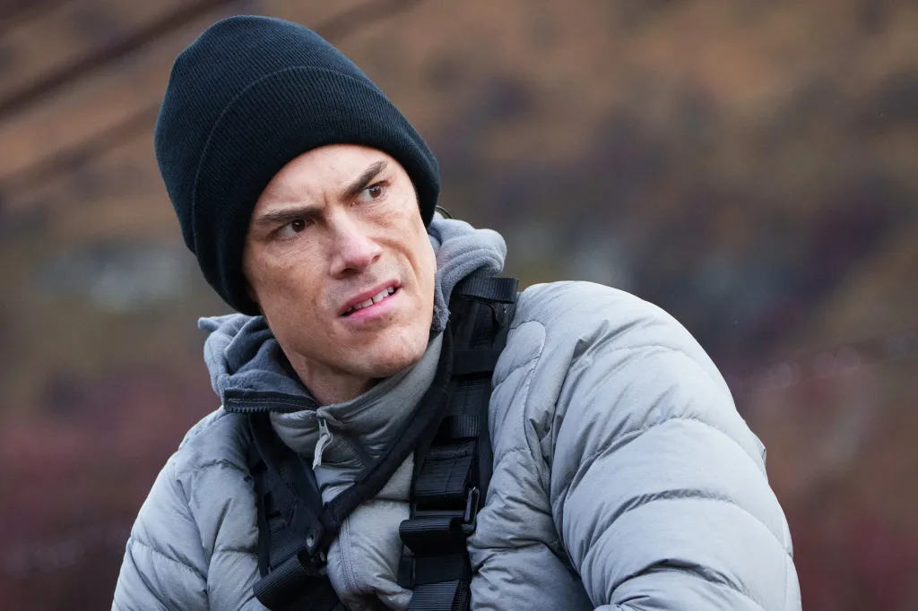 Tom Sandoval looking concerned in a black beanie and grey puffer jacket.
