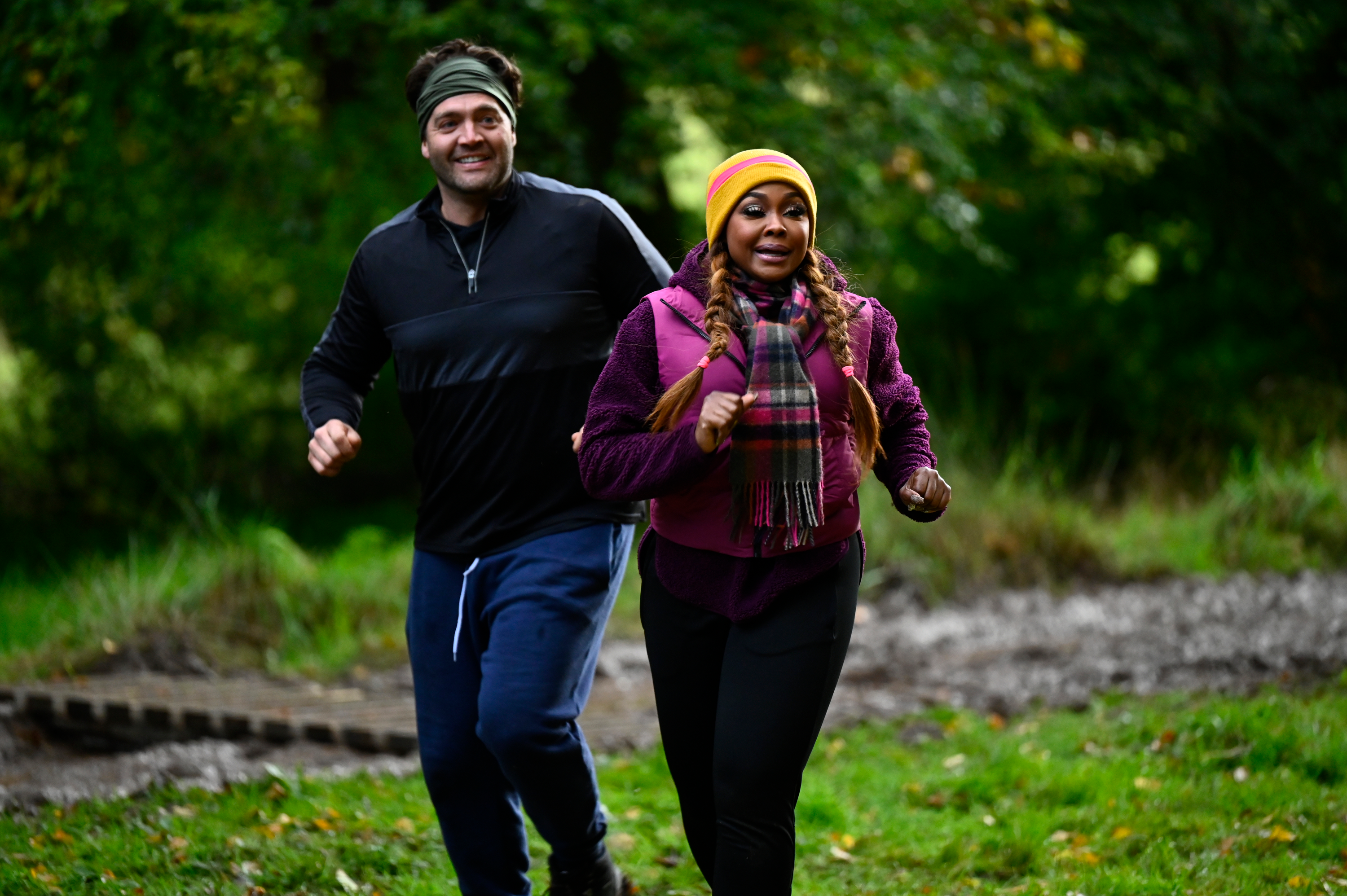 Chris 'C.T.' Tamburello and Phaedra Parks running outdoors.