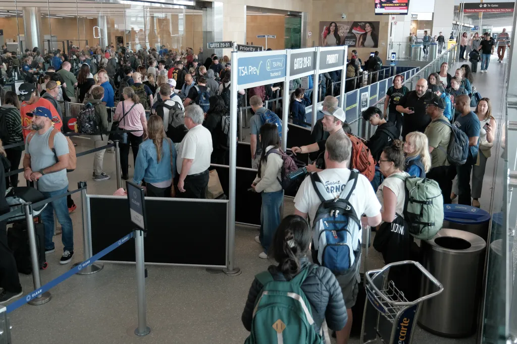 Travelers wait in long security lines at San Diego International Airport amid TSA staffing shortages.