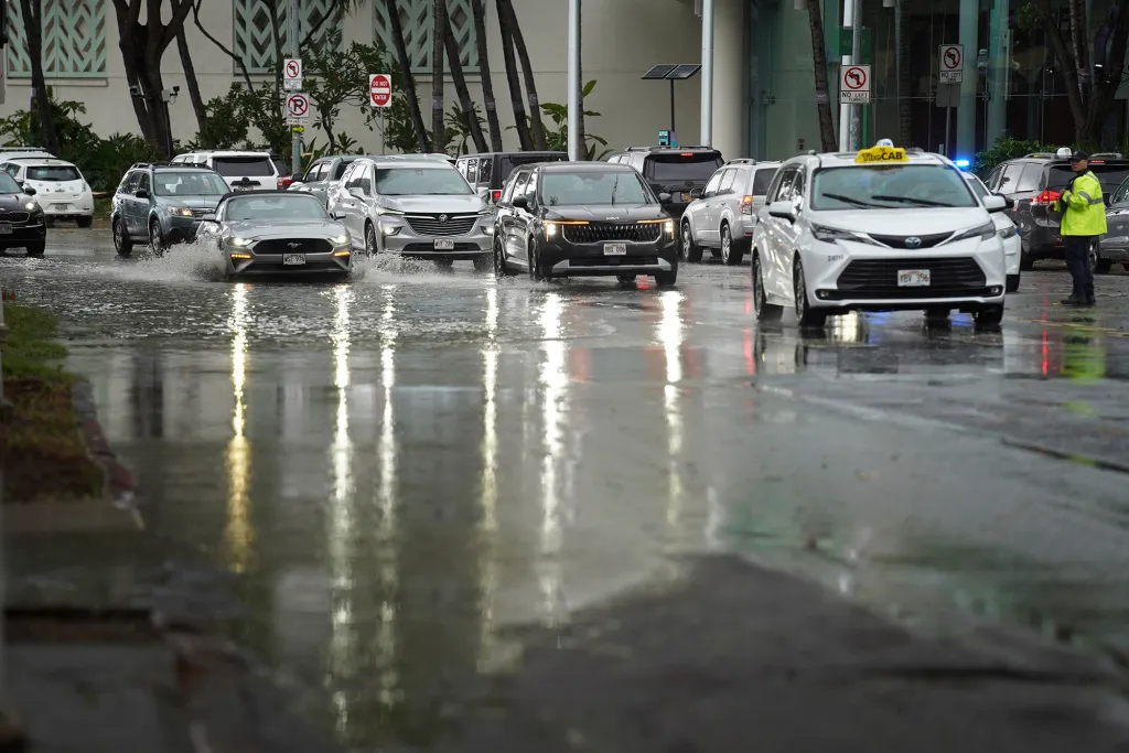 Cars driving through a flooded Kapiolani Boulevard in Honolulu during Tropical Storm Lala.