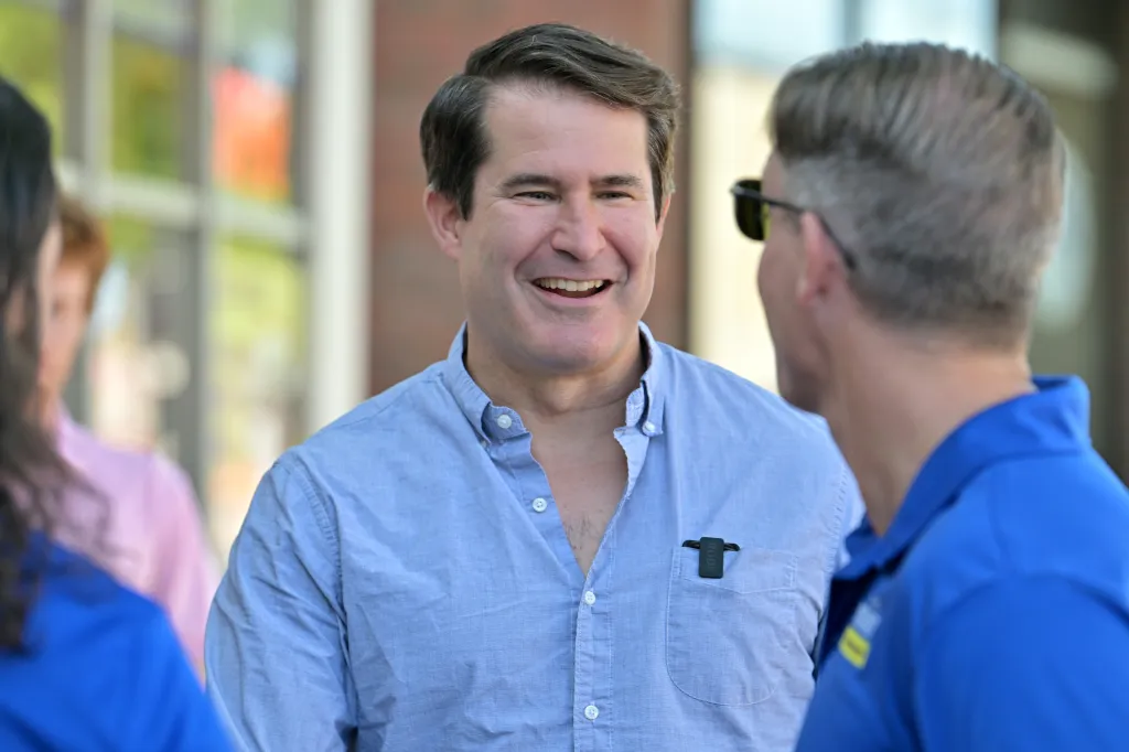 U.S. Rep. Seth Moulton smiling and speaking to prospective voters.
