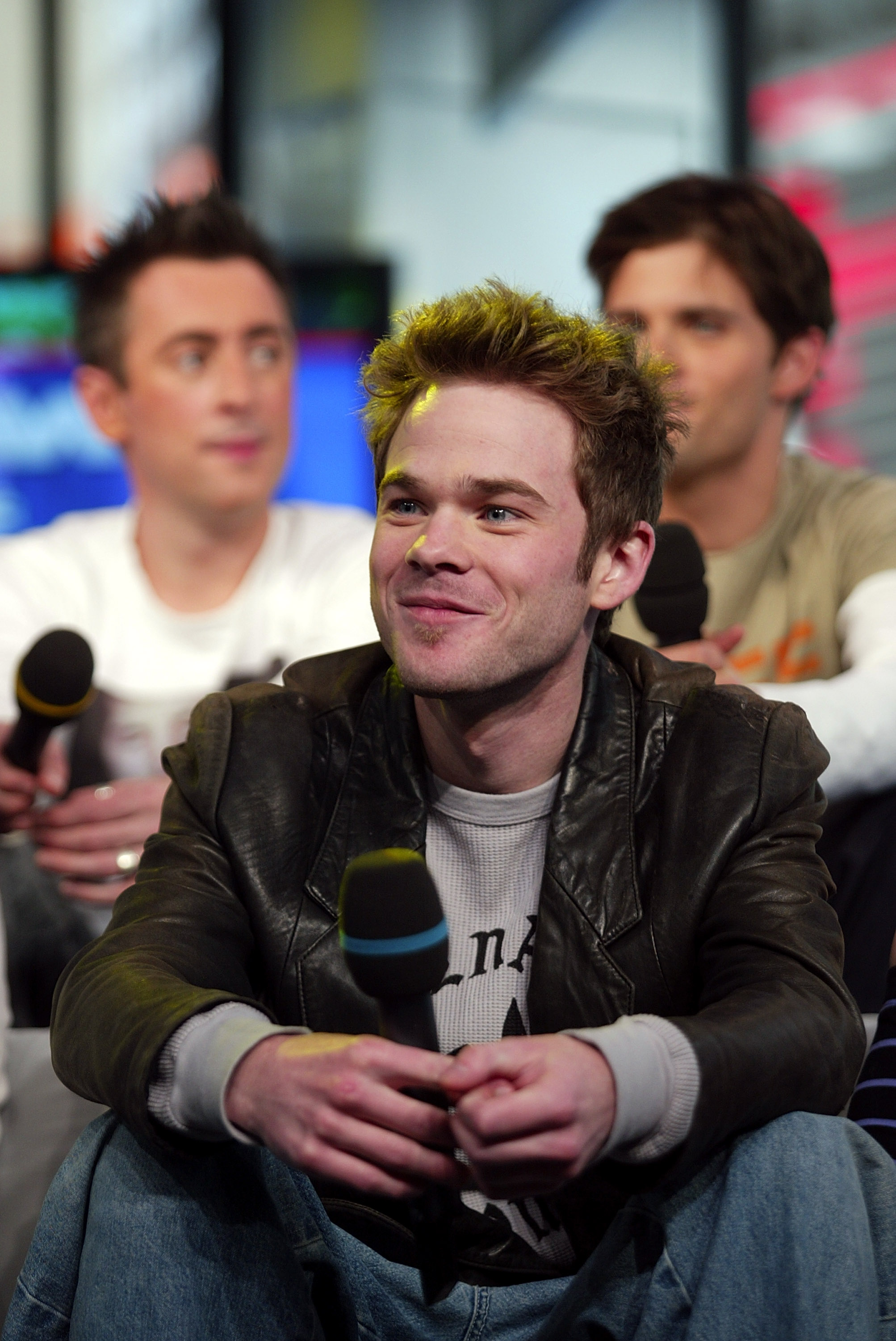 Actor Shawn Ashmore speaking into a microphone.
