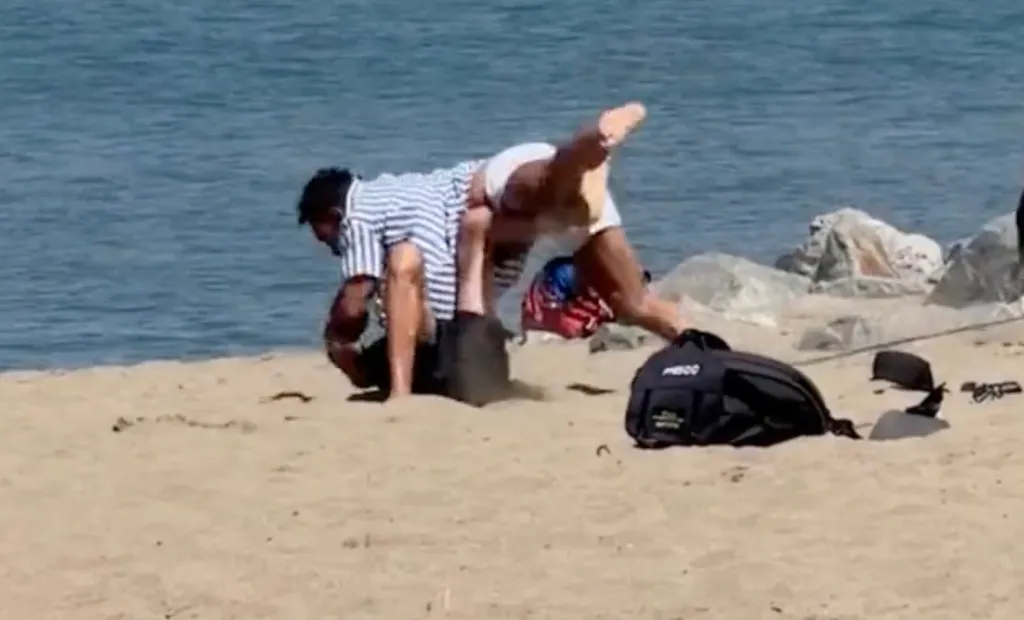 James Hidalgo (left) and an unidentified man fighting on a San Francisco beach.