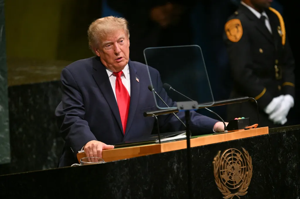 Donald Trump at a podium with the UN logo.