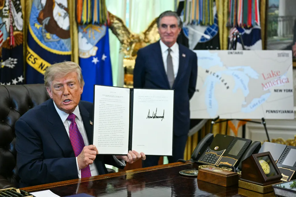President Trump and Secretary of the Interior Doug Burgum display an executive order Trump signed to rename Lake Ontario to Lake America in the Oval Office of the White House in Washington, DC, on Aug. 27, 2026.