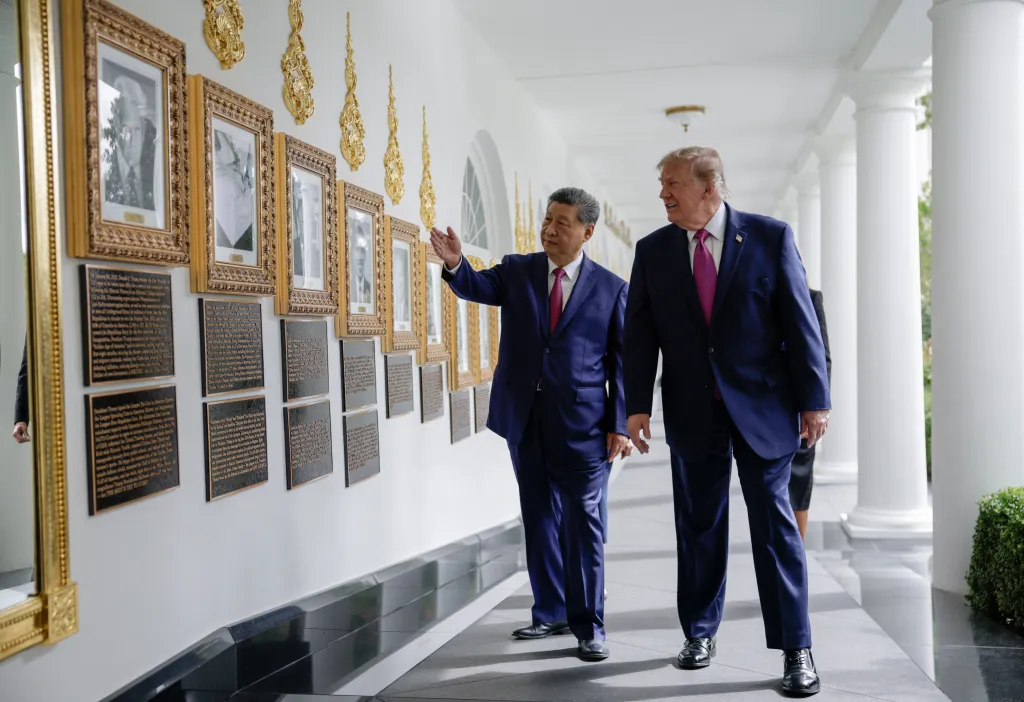 US President Donald Trump and China's President Xi Jinping look at an image of an autopen signing former U.S. President Joe Biden's signature at the 