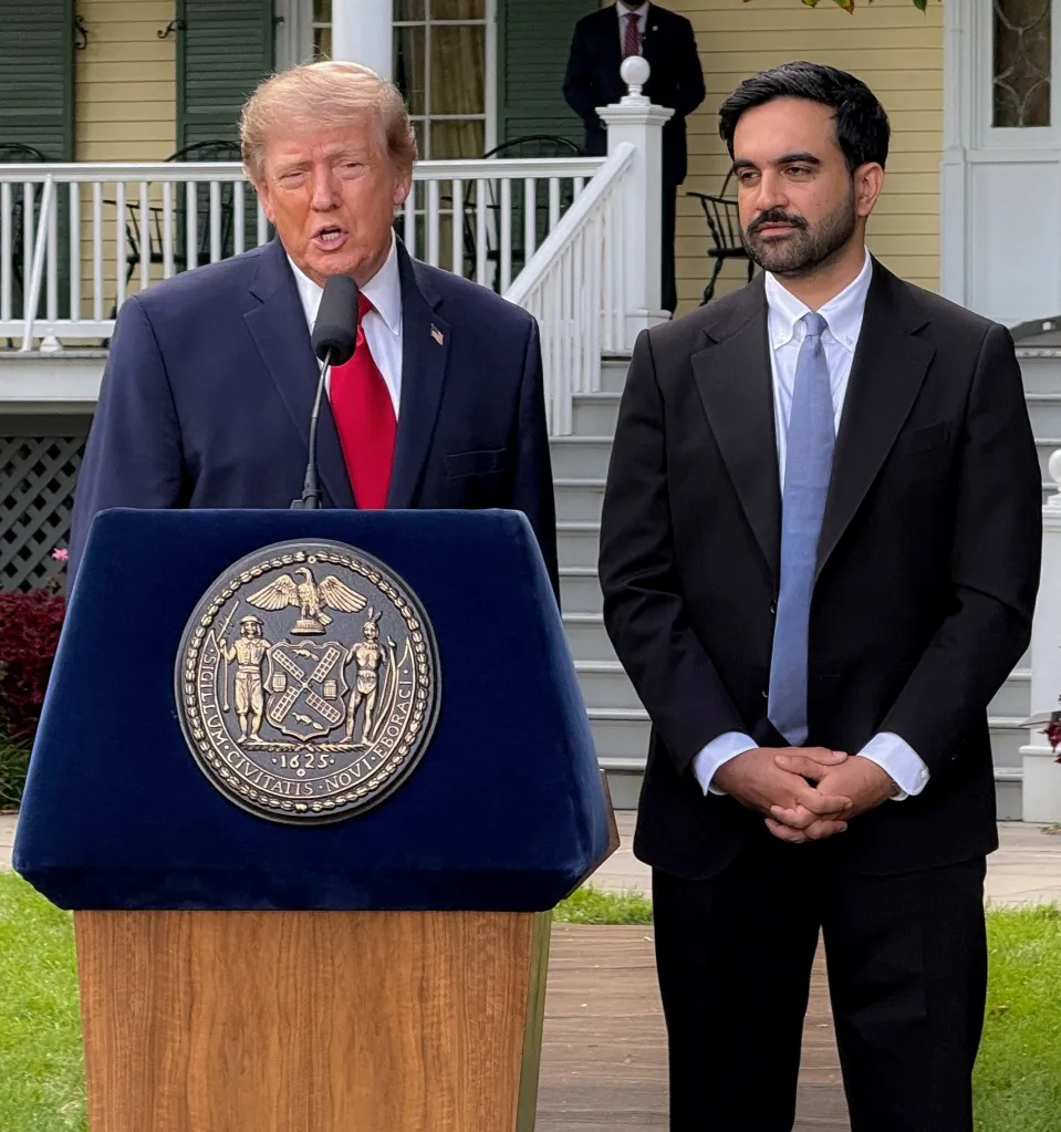 Donald Trump speaking at a podium with Zohran Mamdani standing beside him at a press conference.