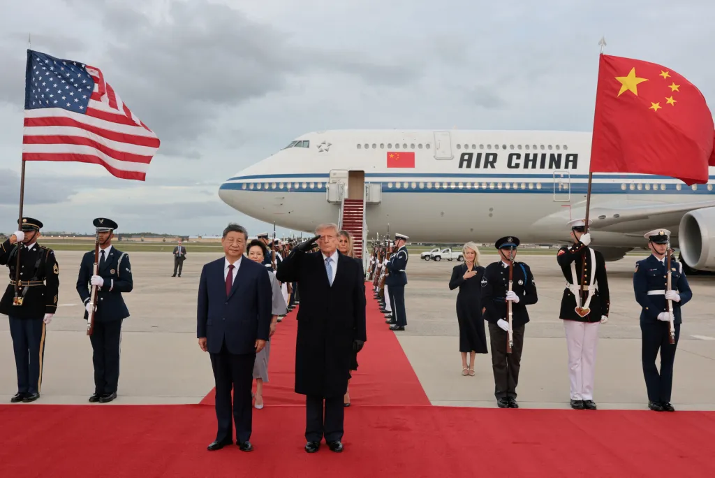 US President Donald Trump salutes next to Chinese President Xi Jinping during his arrival at Joint Base Andrews.