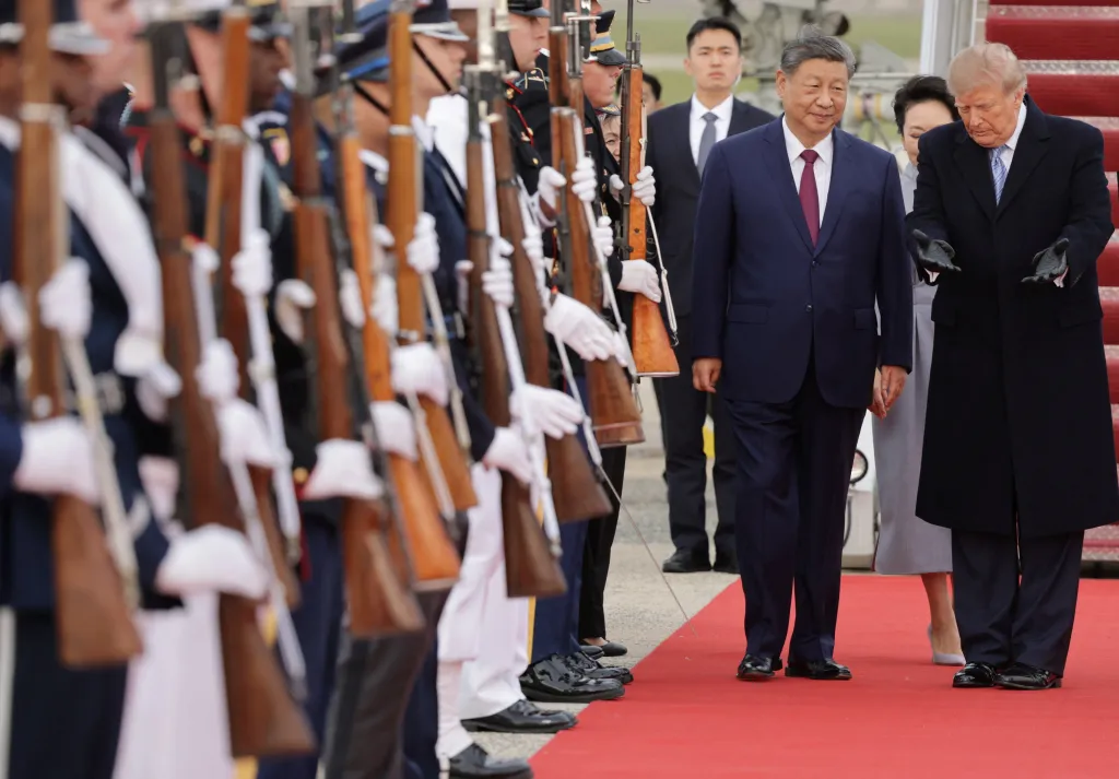 US President Donald Trump welcomes Chinese President Xi Jinping at Joint Base Andrews with a line of service members holding rifles.
