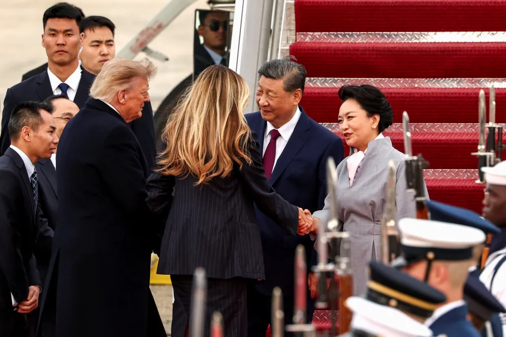 President Donald Trump and First Lady Melania Trump greet President Xi Jinping and his wife Peng Liyuan on an airplane tarmac.