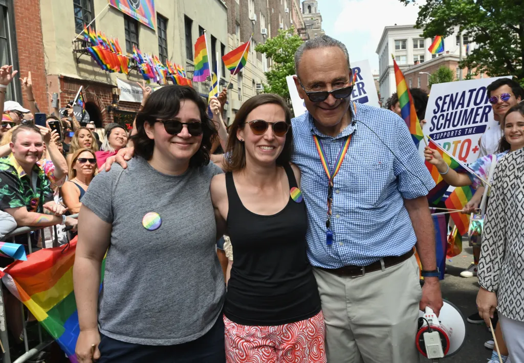 Alison Schumer, center, is pictured with her father, Senate Minority Leader Chuck Schumer, and her wife, Elizabeth Weiland.