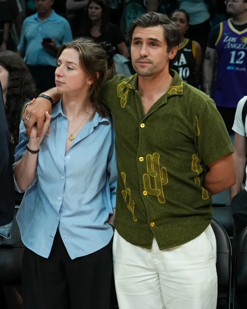 Phil Dunster and Ellie Heydon at a WNBA basketball game.