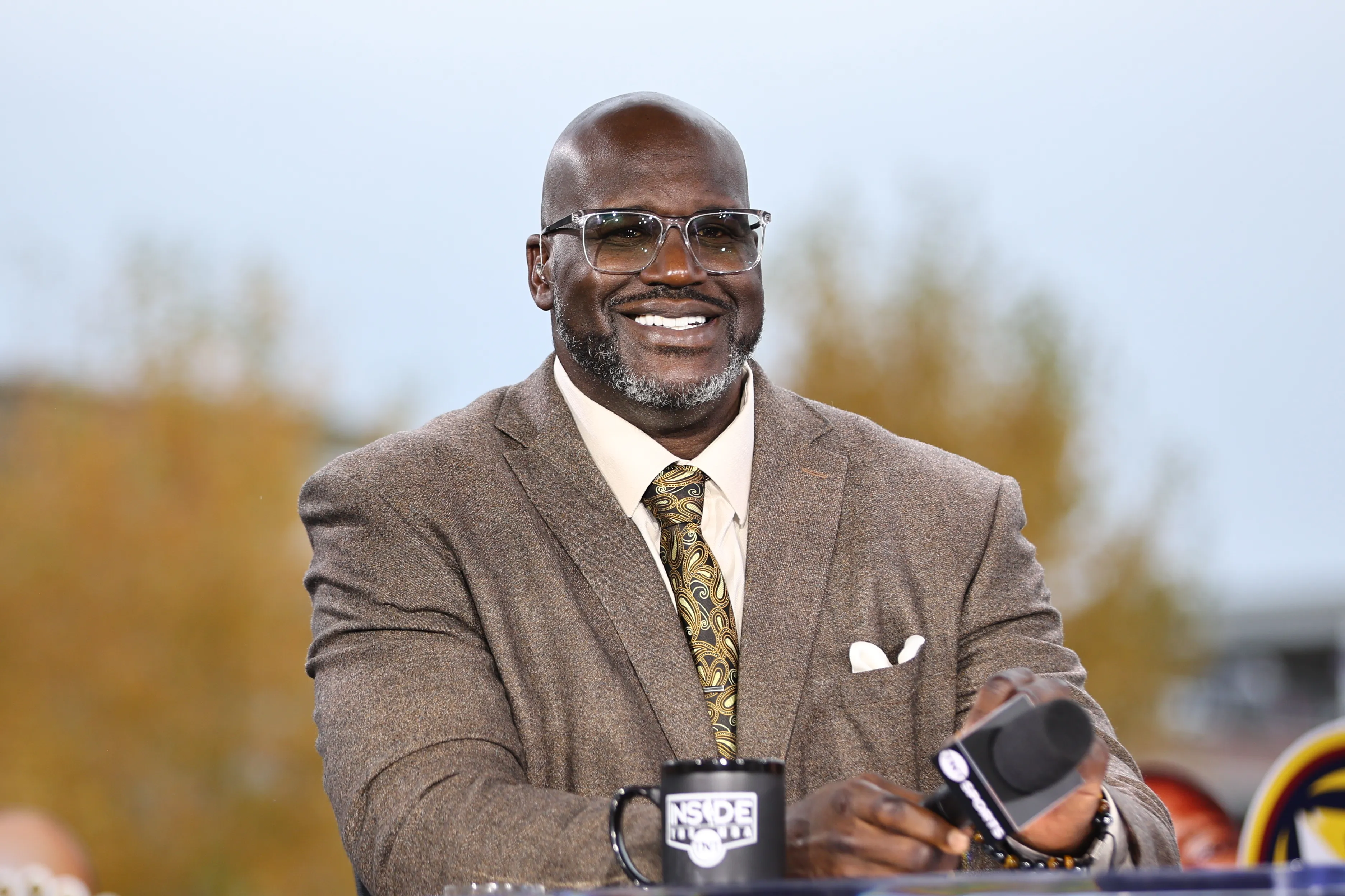 Shaquille O'Neal smiling at the TNT NBA Tip-Off broadcast.